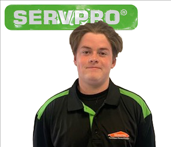 Evan, male, SERVPRO employee against a white background and green SERVPRO logo