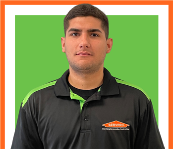 SERVPRO employee in front of green background